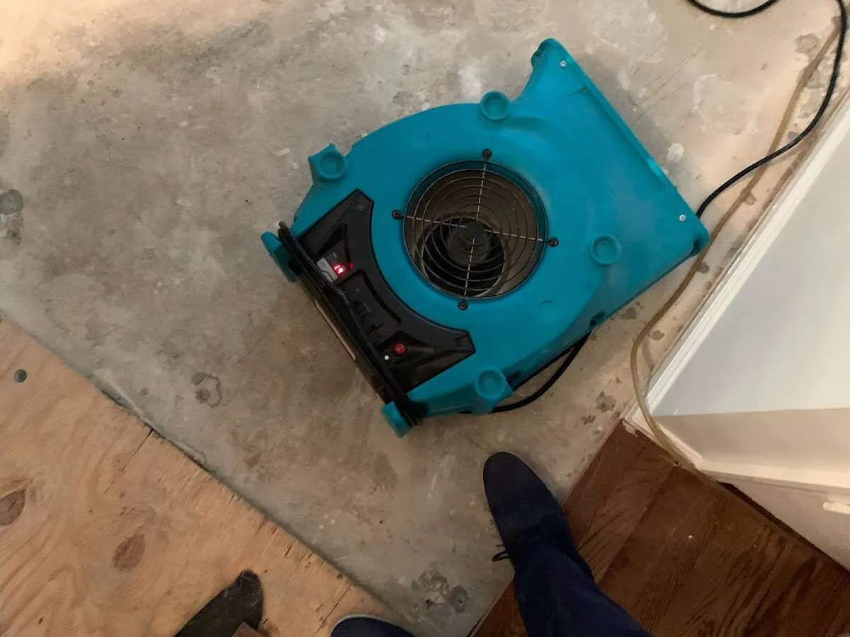 Air mover drying subfloor during Commercial Water Damage Restoration in Marietta